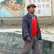 An ethnic Uyghur man walks past a sign that says “implementing family planning is in the interest of the country, people, and posterity” on the outskirts of Khotan in Xinjiang province.
